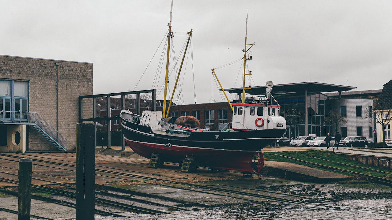 awards-img A fishing boat on a dock in Husum, Germany, under a gloomy sky.